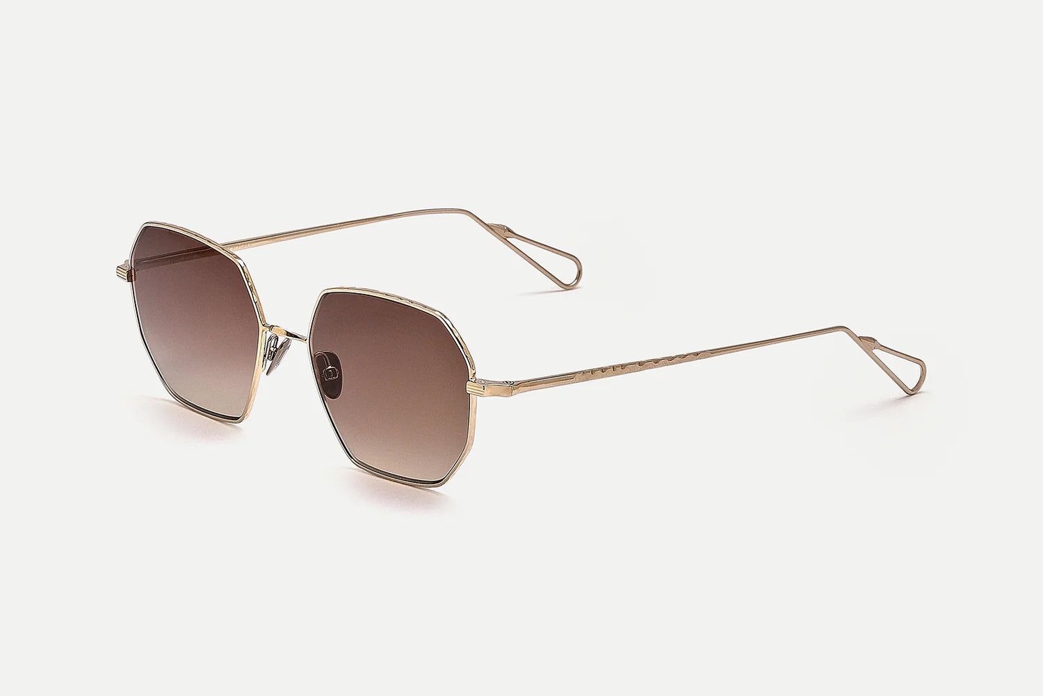 Gold-framed sunglasses with gradient lenses on a white background