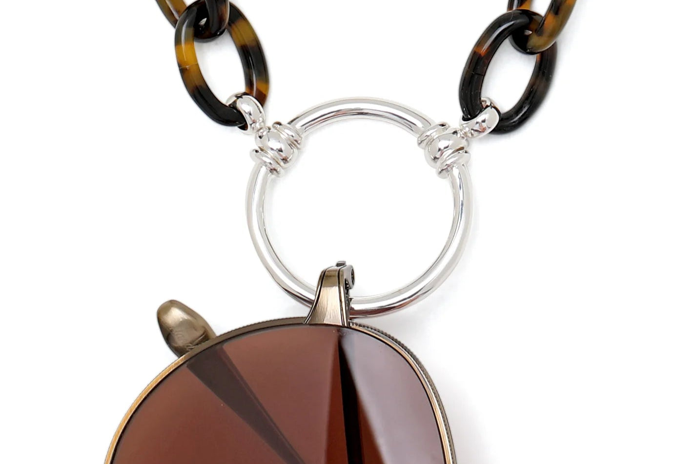 Necklace with tortoiseshell chain and round pendant on a white background